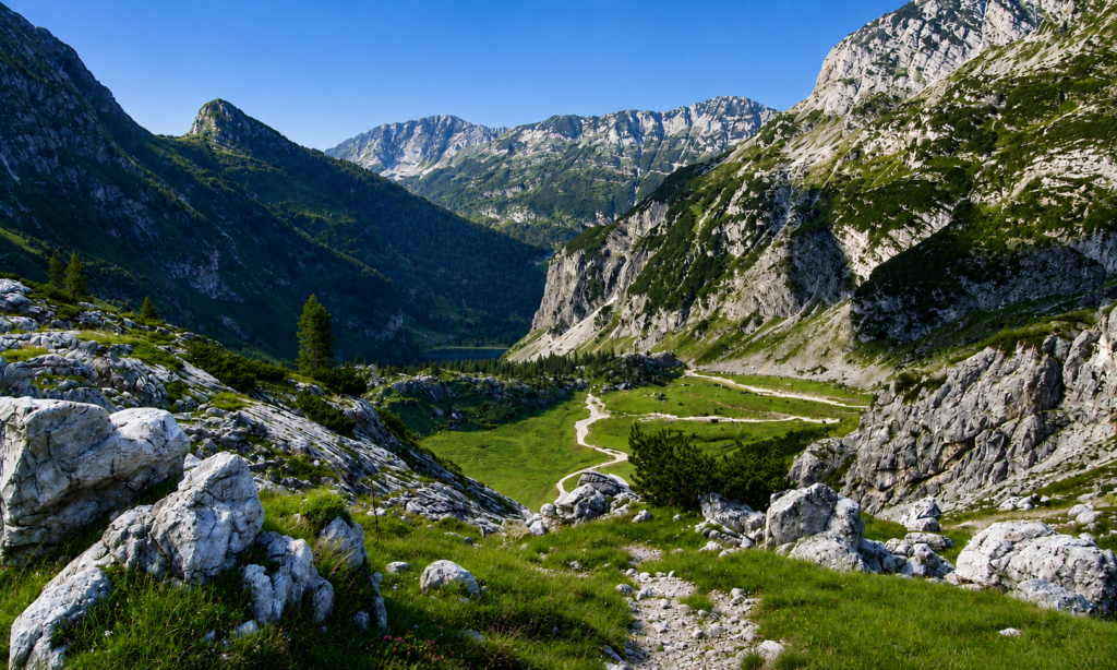 Panoramic view of Lake Krn nestled in a glacial basin beneath the slopes of Mount Krn in Triglav National Park.