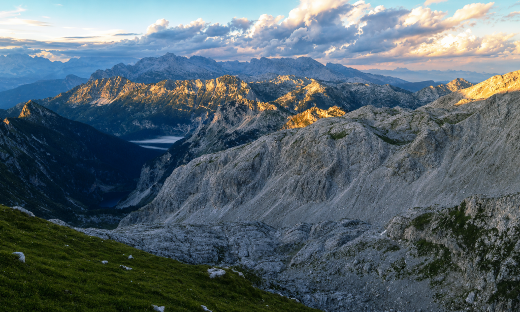 Aerial view of Lake Krn in the Julian Alps, Slovenia, showing the glacial basin and surrounding limestone peaks.